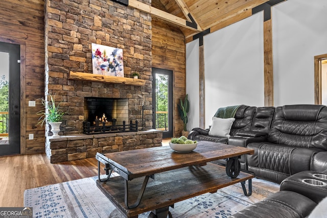 795 E Jones Chapel Rd, Danielsville, GA 30633 - living area with a wood ceiling with exposed beams, high vaulted ceiling, wood-type flooring, a fireplace, and wooden walls