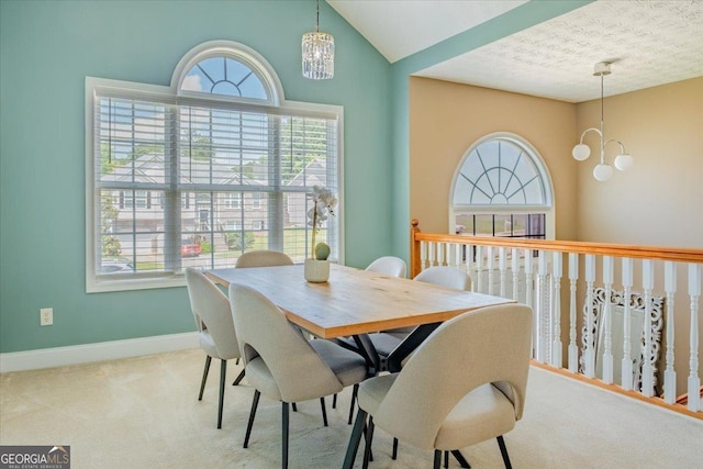 4348 Tillage Path, Douglasville, GA 30135 - dining room featuring a chandelier, healthy amount of natural light, carpet flooring, vaulted ceiling, and a textured ceiling