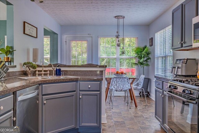 4348 Tillage Path, Douglasville, GA 30135 - kitchen featuring dishwasher, range with gas stovetop, a sink, dark countertops, and a textured ceiling