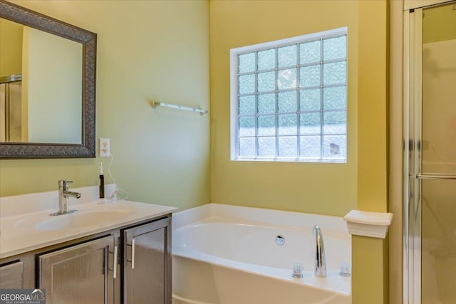 4348 Tillage Path, Douglasville, GA 30135 - bathroom with a garden tub, vanity, and a stall shower