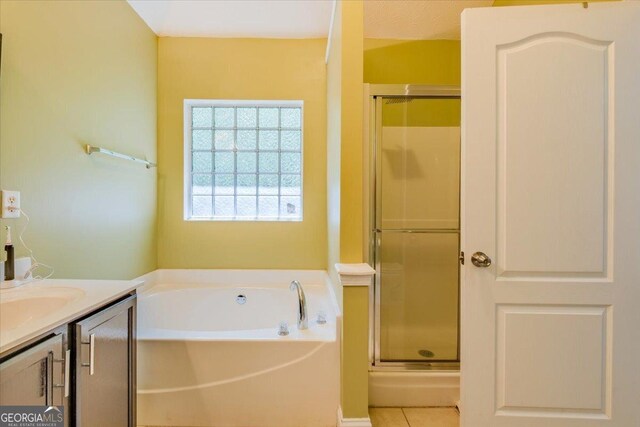 4348 Tillage Path, Douglasville, GA 30135 - full bathroom with a stall shower, a garden tub, vanity, and tile patterned flooring