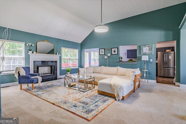 4348 Tillage Path, Douglasville, GA 30135 - living area featuring carpet floors, plenty of natural light, a fireplace, baseboards, and high vaulted ceiling