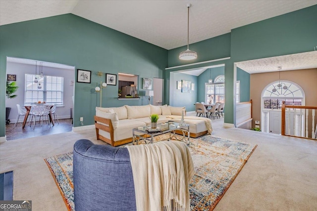 4348 Tillage Path, Douglasville, GA 30135 - living area with carpet floors, a chandelier, high vaulted ceiling, and baseboards