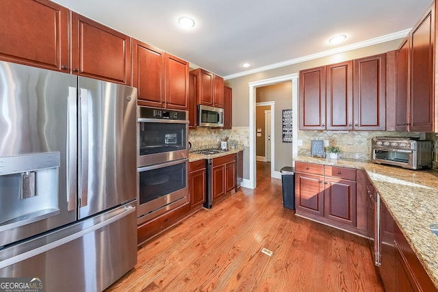 168 Observation Pt, Dallas, GA 30132 - kitchen with stainless steel appliances, ornamental molding, light wood-style floors, backsplash, and light stone countertops