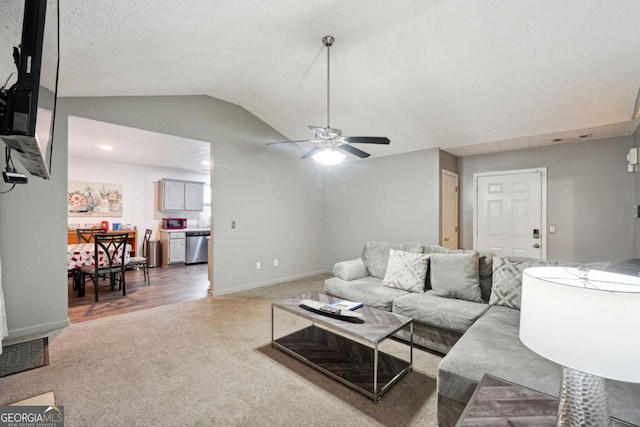 11529 Vinea Ln, Hampton, GA 30228 - carpeted living area featuring vaulted ceiling, a ceiling fan, and baseboards