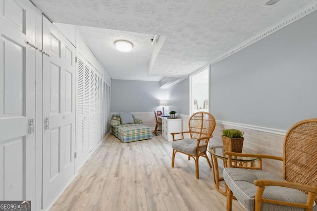 4205 Jeri Lynn Ct, Tucker, GA 30084 - sitting room featuring a textured ceiling, light wood finished floors, and a wainscoted wall