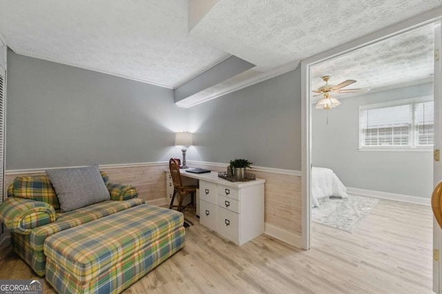 4205 Jeri Lynn Ct, Tucker, GA 30084 - living area with a textured ceiling, light wood-style flooring, a ceiling fan, an office area, and a wainscoted wall