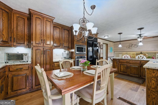 4205 Jeri Lynn Ct, Tucker, GA 30084 - dining room with light wood-style floors, a chandelier, a ceiling fan, and crown molding