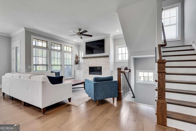 3108 Huntington Pl, Milton, GA 30004 - living room with ceiling fan, light wood-style floors, recessed lighting, a fireplace, and ornamental molding