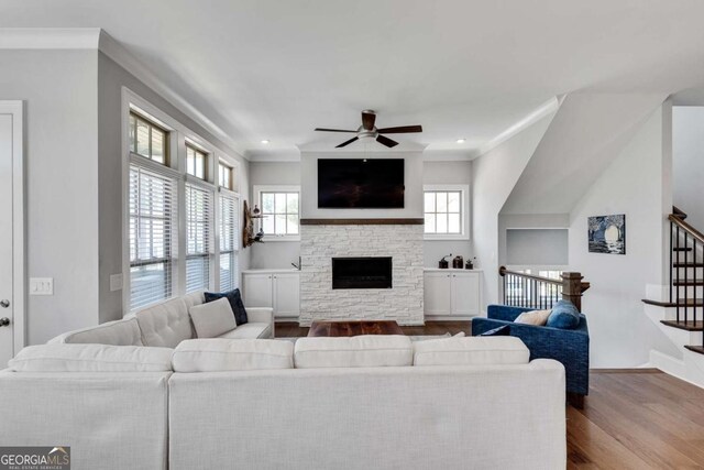 3108 Huntington Pl, Milton, GA 30004 - living room featuring wood finished floors, healthy amount of natural light, stairway, ceiling fan, and ornamental molding