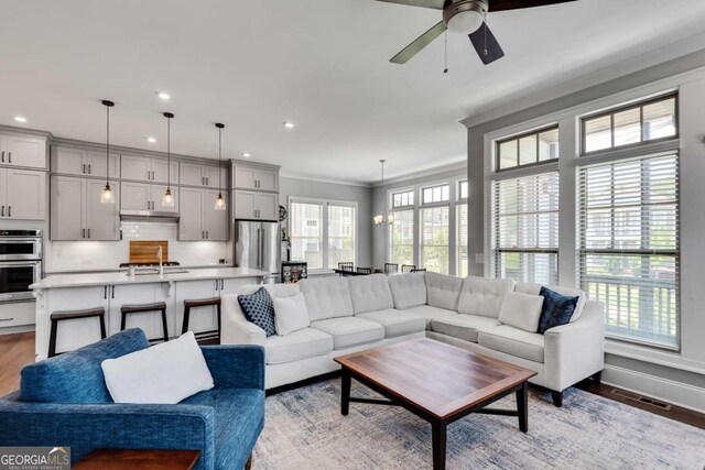 3108 Huntington Pl, Milton, GA 30004 - living area featuring ceiling fan, light wood-style flooring, crown molding, recessed lighting, and baseboards
