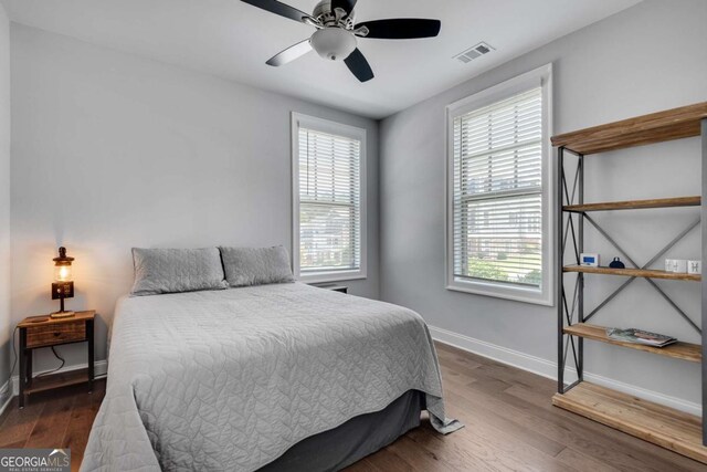 3108 Huntington Pl, Milton, GA 30004 - bedroom with multiple windows, baseboards, and wood finished floors