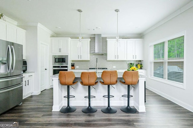 282 Brant Cir, Jefferson, GA 30549 - kitchen featuring appliances with stainless steel finishes, wall chimney range hood, crown molding, and white cabinetry