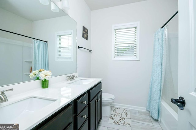 282 Brant Cir, Jefferson, GA 30549 - bathroom with double vanity, shower / bath combo with shower curtain, toilet, and baseboards