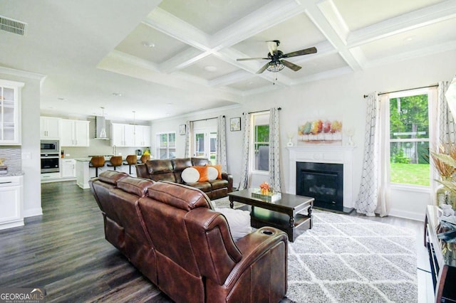 282 Brant Cir, Jefferson, GA 30549 - living area featuring dark wood-type flooring, beamed ceiling, ceiling fan, a glass covered fireplace, and coffered ceiling