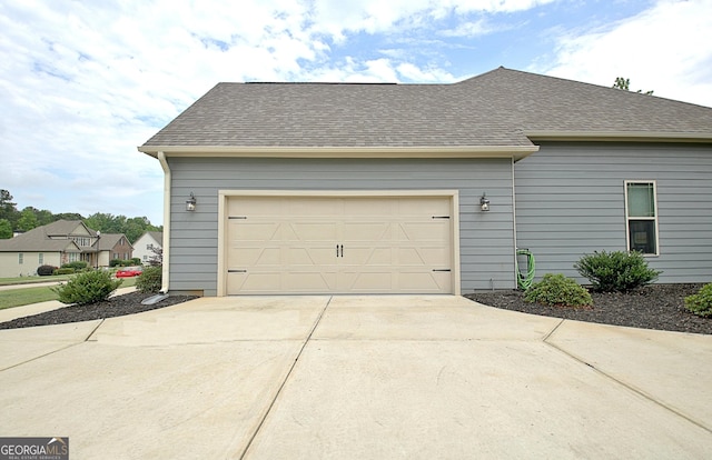 234 Thyme Leaf Way, Locust Grove, GA 30248 - view of side of property featuring driveway, roof with shingles, and a garage