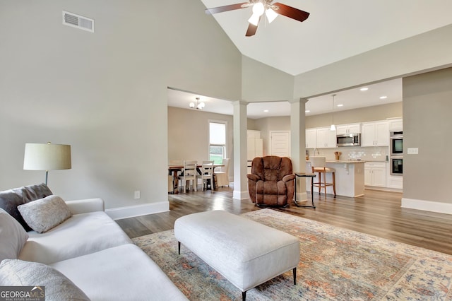 234 Thyme Leaf Way, Locust Grove, GA 30248 - living area featuring decorative columns, a ceiling fan, light wood-style flooring, baseboards, and high vaulted ceiling