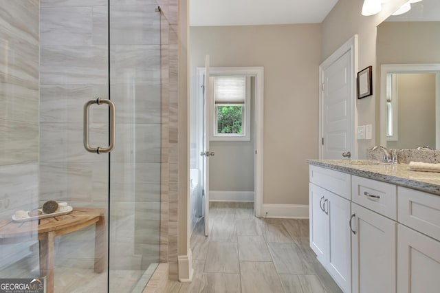 234 Thyme Leaf Way, Locust Grove, GA 30248 - bathroom with vanity, a stall shower, baseboards, and marble look tile flooring