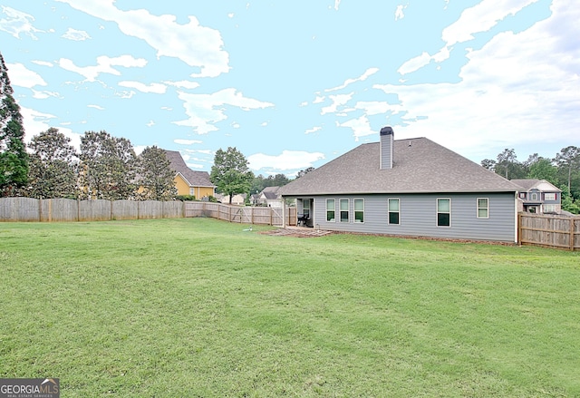 234 Thyme Leaf Way, Locust Grove, GA 30248 - back of house with a chimney and roof with shingles