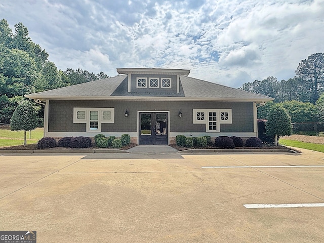 234 Thyme Leaf Way, Locust Grove, GA 30248 - view of front of property featuring french doors, a shingled roof, and uncovered parking