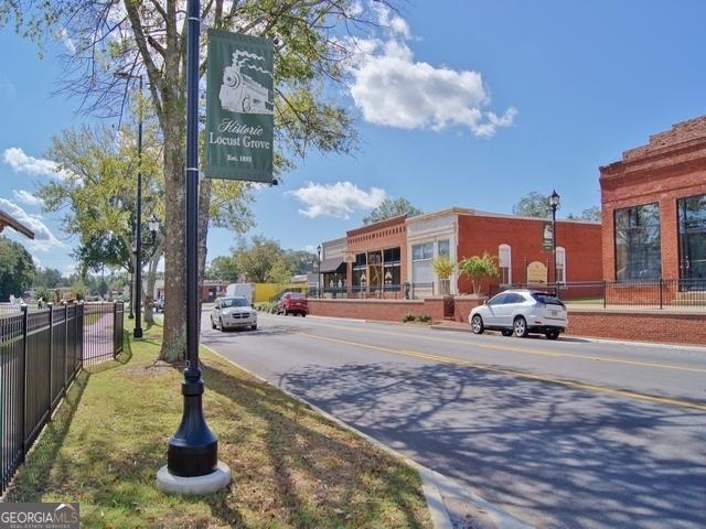 234 Thyme Leaf Way, Locust Grove, GA 30248 - view of asphalt street featuring curbs and sidewalks