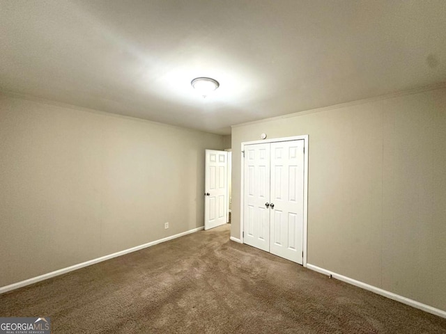 2239 Nelms Dr SW, Atlanta, GA 30315 - unfurnished bedroom featuring baseboards, dark colored carpet, and a closet
