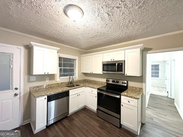 2239 Nelms Dr SW, Atlanta, GA 30315 - kitchen featuring stainless steel appliances, a sink, dark wood-type flooring, ornamental molding, and a textured ceiling
