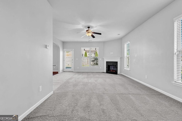 4238 Sir Dixon Dr, Fairburn, GA 30213 - unfurnished living room featuring a ceiling fan, baseboards, carpet, and arched walkways