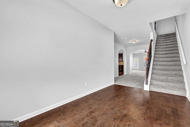 4238 Sir Dixon Dr, Fairburn, GA 30213 - foyer featuring arched walkways, stairs, baseboards, and wood finished floors