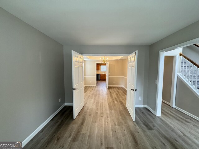 3292 Shady Valley Ct, Loganville, GA 30052 - hallway with a chandelier, stairs, and wood finished floors