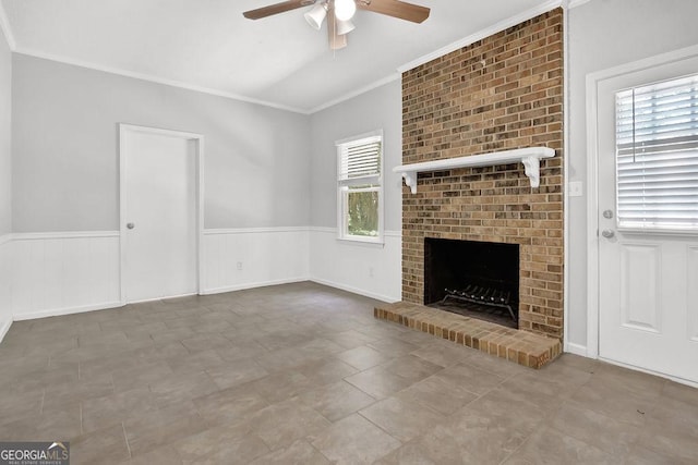 752 Roxboro Trce, Lawrenceville, GA 30044 - unfurnished living room featuring ceiling fan, crown molding, a wainscoted wall, a fireplace, and vaulted ceiling