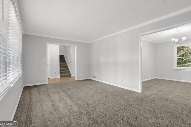 752 Roxboro Trce, Lawrenceville, GA 30044 - spare room with carpet floors, stairs, crown molding, a chandelier, and baseboards