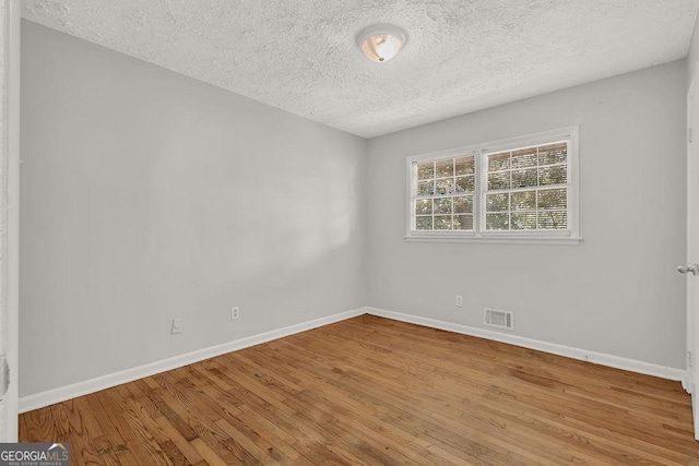2261 Star Mist Dr SW, Atlanta, GA 30311 - unfurnished room with a textured ceiling, wood finished floors, and baseboards