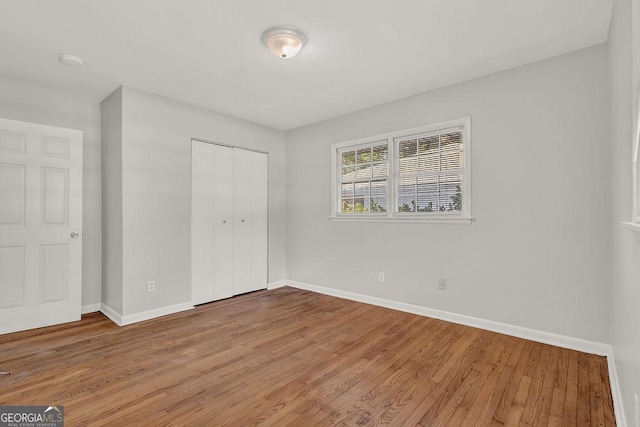 2261 Star Mist Dr SW, Atlanta, GA 30311 - unfurnished bedroom featuring baseboards, light wood-type flooring, and a closet