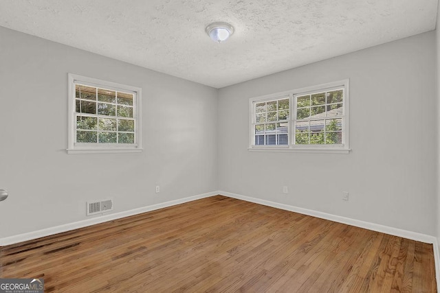 2261 Star Mist Dr SW, Atlanta, GA 30311 - spare room featuring wood finished floors, baseboards, and a textured ceiling