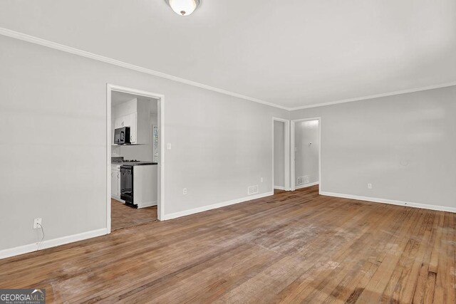 2261 Star Mist Dr SW, Atlanta, GA 30311 - empty room featuring ornamental molding, wood finished floors, and baseboards
