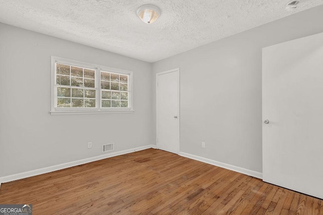 2261 Star Mist Dr SW, Atlanta, GA 30311 - unfurnished room with wood finished floors, a textured ceiling, and baseboards