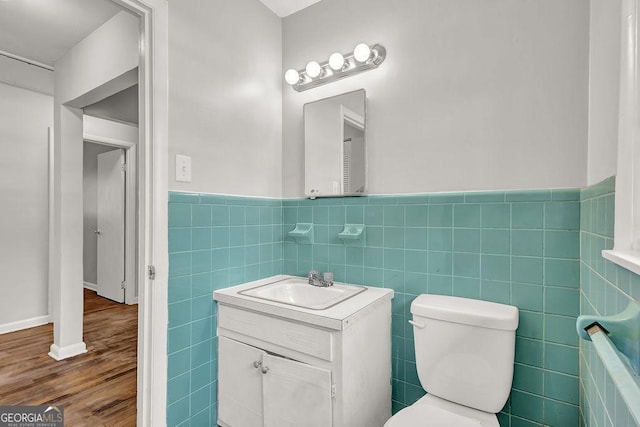 2261 Star Mist Dr SW, Atlanta, GA 30311 - full bath with vanity, tile walls, toilet, wood finished floors, and a wainscoted wall