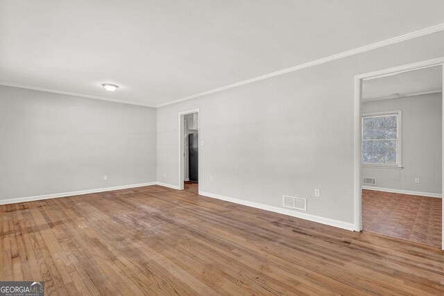 2261 Star Mist Dr SW, Atlanta, GA 30311 - empty room with ornamental molding, wood finished floors, and baseboards