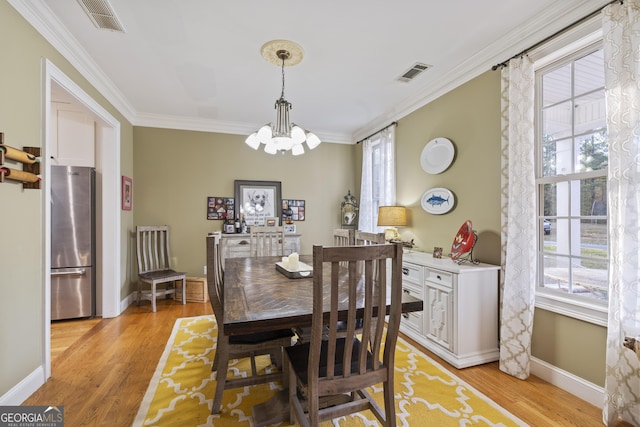 572 Austin Rd, Newnan, GA 30263 - dining space with a chandelier, ornamental molding, light wood-style flooring, and baseboards