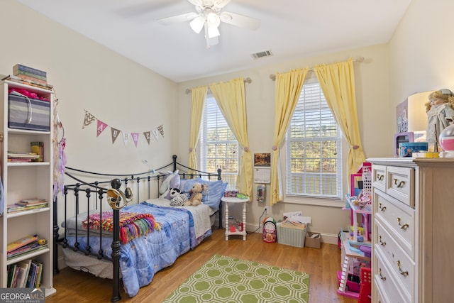 572 Austin Rd, Newnan, GA 30263 - bedroom with wood finished floors, a ceiling fan, and baseboards