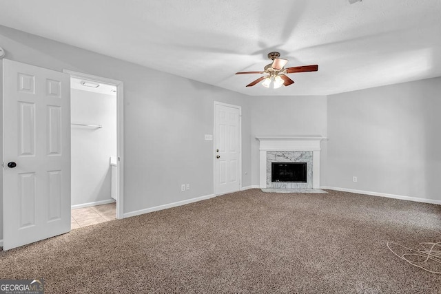 6541 Lazy Creek Ct, Lithonia, GA 30058 - unfurnished living room with carpet, a ceiling fan, a fireplace, and baseboards