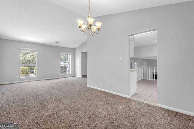 6541 Lazy Creek Ct, Lithonia, GA 30058 - carpeted empty room with a chandelier, baseboards, lofted ceiling, and tile patterned floors