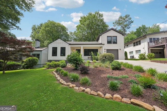 1815 Coventry Rd, Decatur, GA 30030 - view of front of property with board and batten siding, concrete driveway, a garage, and a front yard
