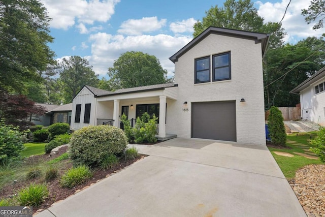 1815 Coventry Rd, Decatur, GA 30030 - view of front of property featuring brick siding, a garage, covered porch, and concrete driveway