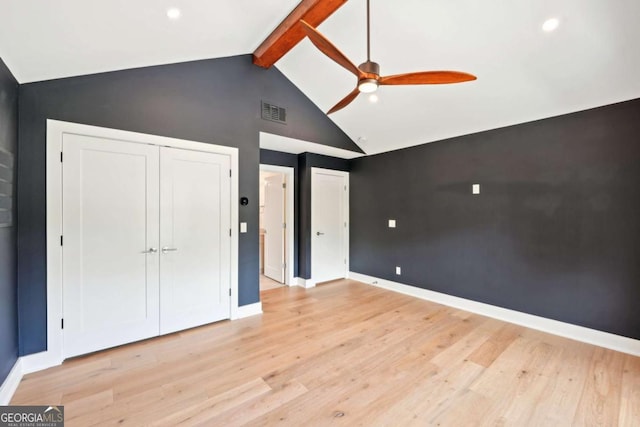 1815 Coventry Rd, Decatur, GA 30030 - unfurnished bedroom with beam ceiling, baseboards, light wood-style flooring, high vaulted ceiling, and multiple closets