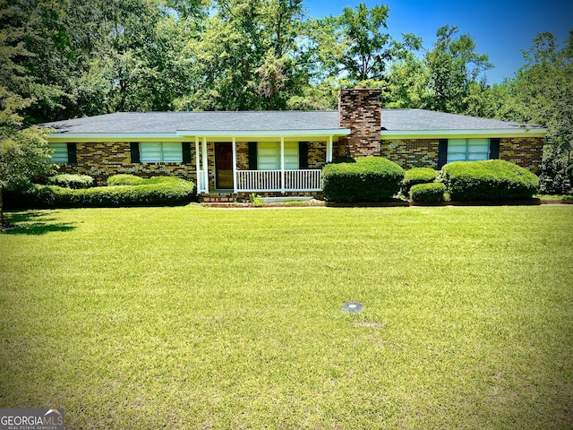 108 Plum St, Dublin, GA 31021 - ranch-style home with a front yard, a porch, and a chimney