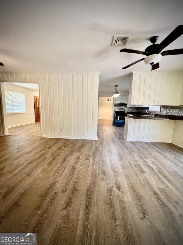 108 Plum St, Dublin, GA 31021 - unfurnished living room with wood finished floors and ceiling fan