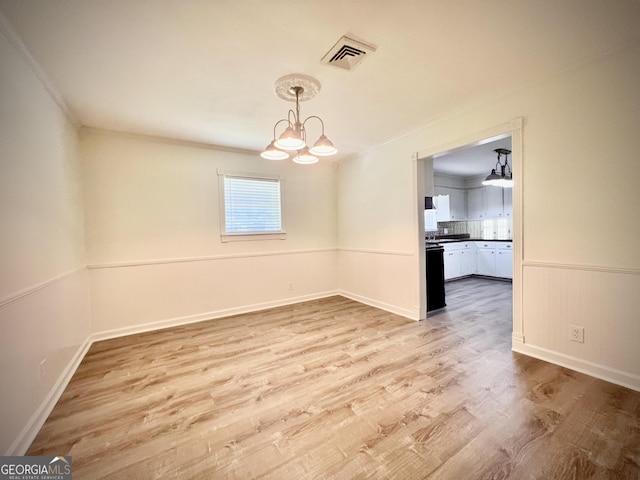 108 Plum St, Dublin, GA 31021 - unfurnished room with a chandelier, wood finished floors, baseboards, and ornamental molding