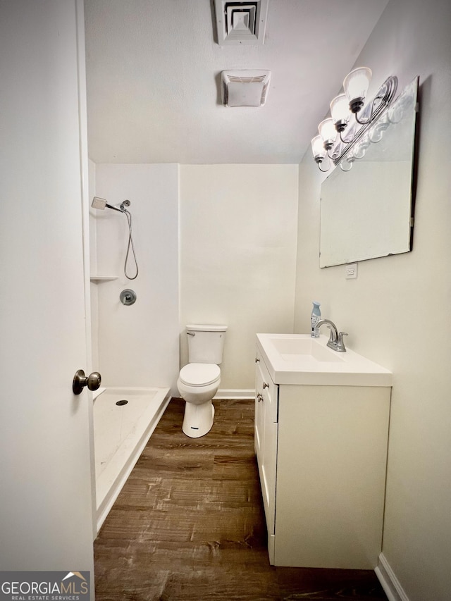 108 Plum St, Dublin, GA 31021 - full bathroom featuring a shower stall, wood finished floors, vanity, toilet, and baseboards